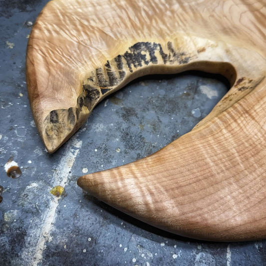 closeup of natural void detail with curled grain surrounding it