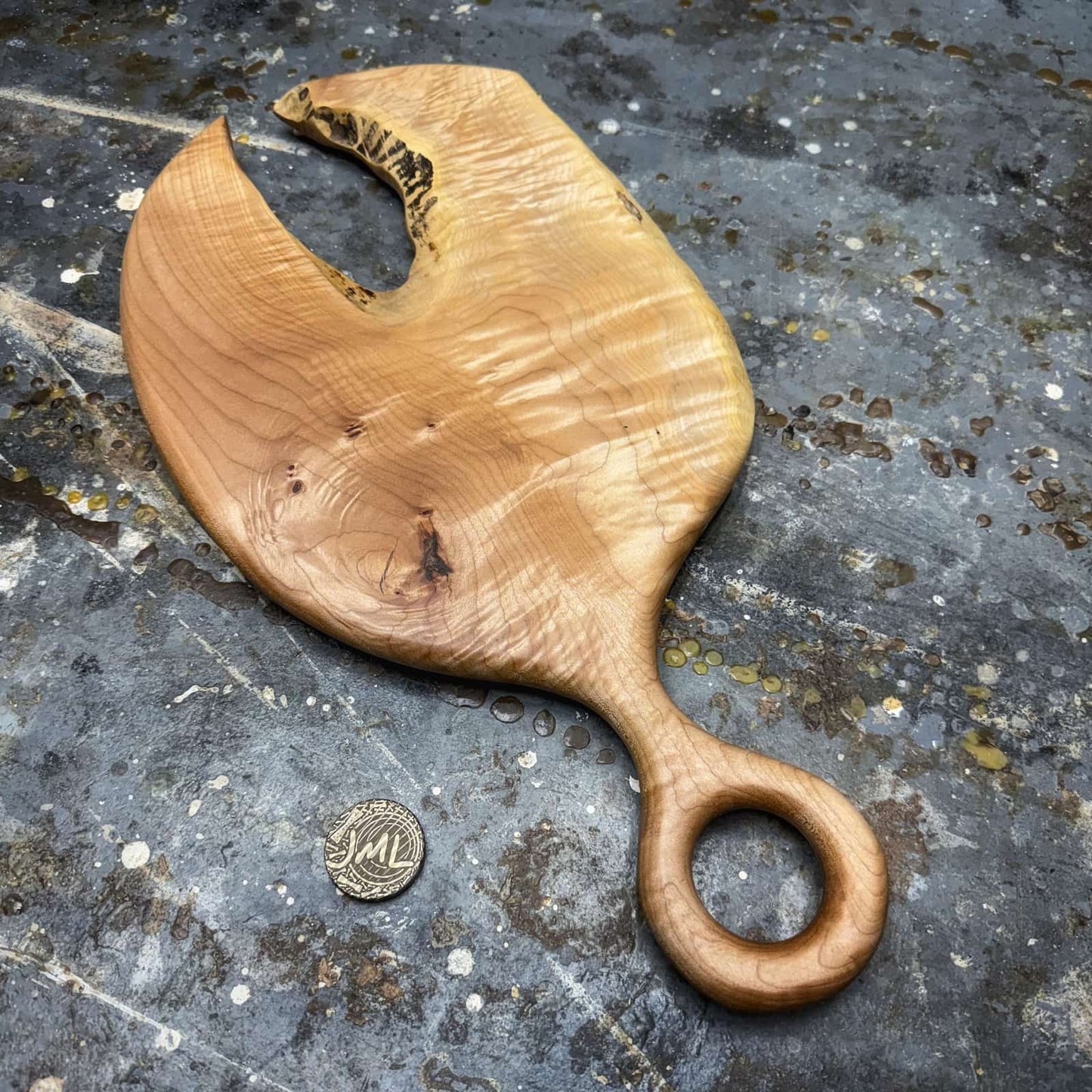 overhead view of curly maple board with lobster claw opening