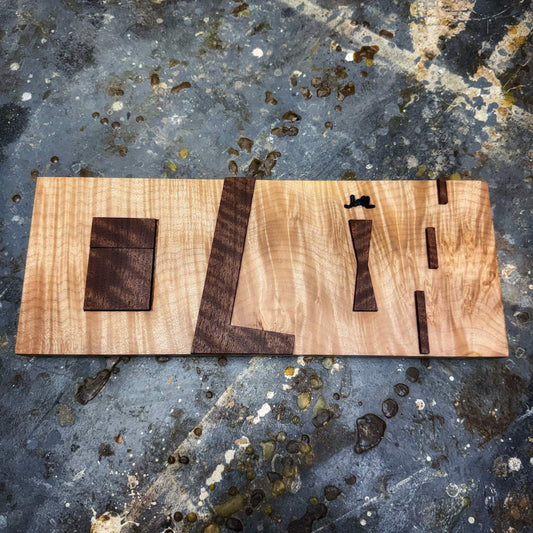 Bandsaw inlay jig showing curly walnut parts on curly maple base