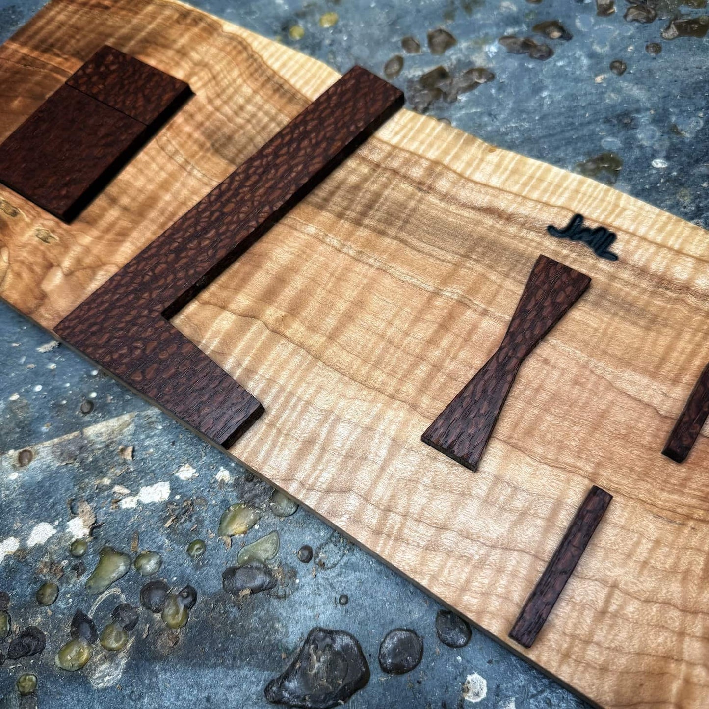 Leopardwood inlay jig parts mounted on figured curly maple base