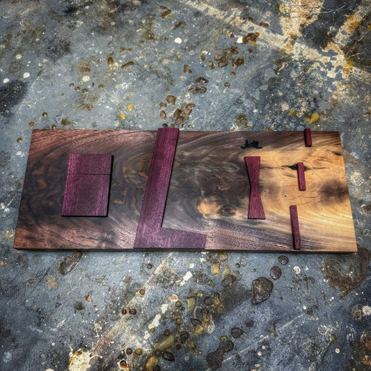 Angled view of walnut base inlay jig showing Purpleheart top parts and layout