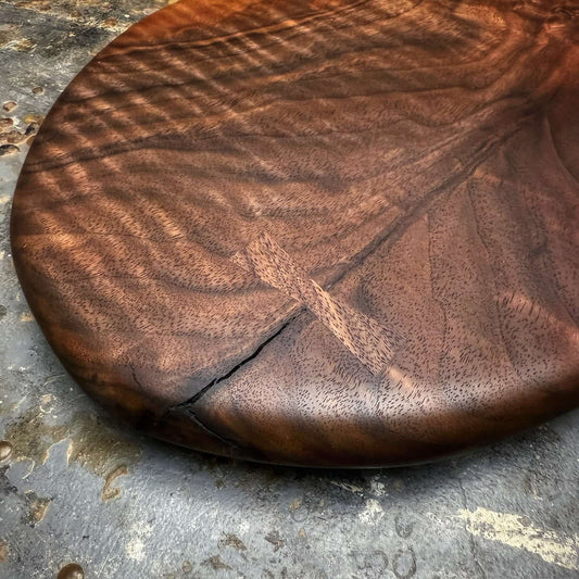 walnut serving board reinforced with hand-cut bow tie inlay