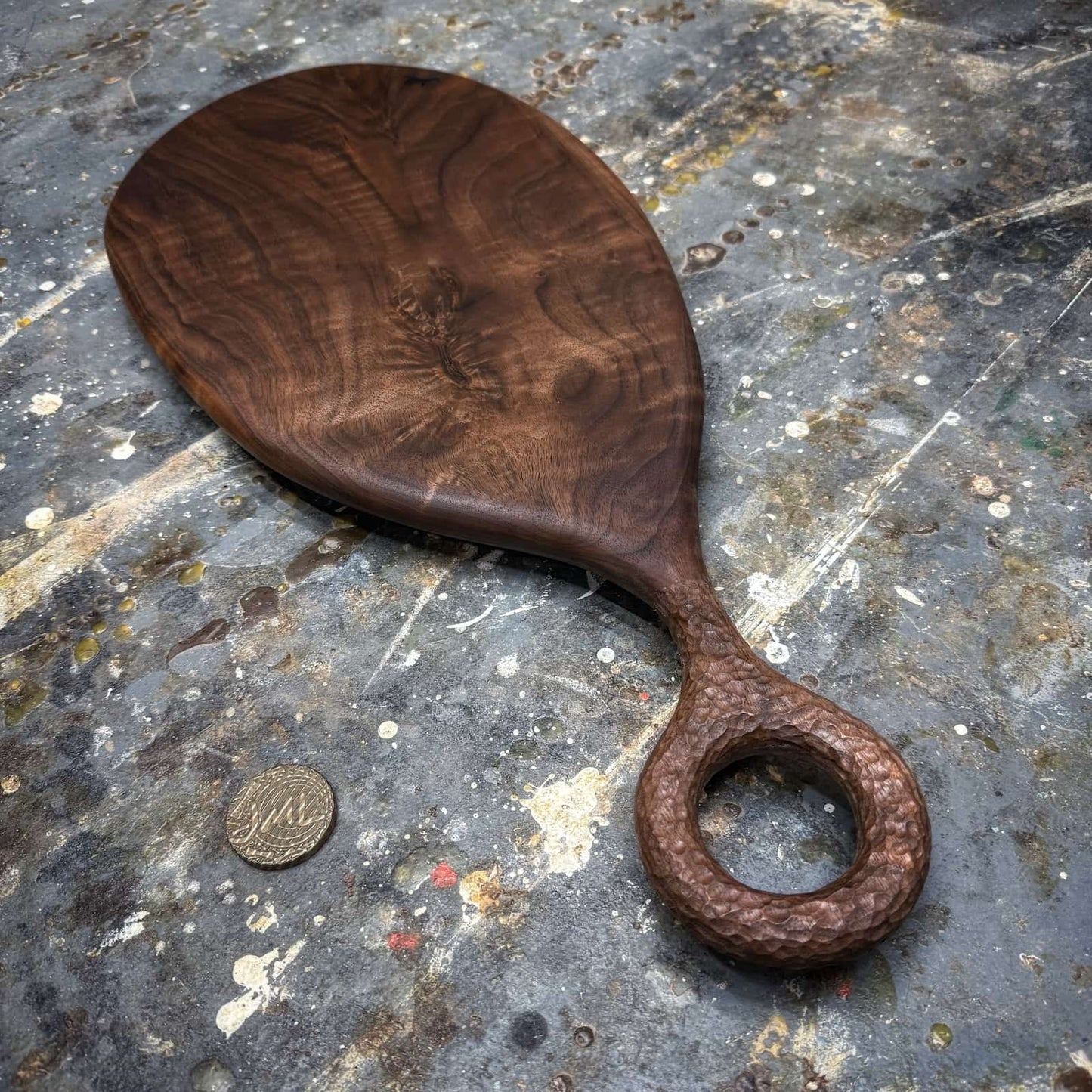 walnut serving board photographed on workshop work surface