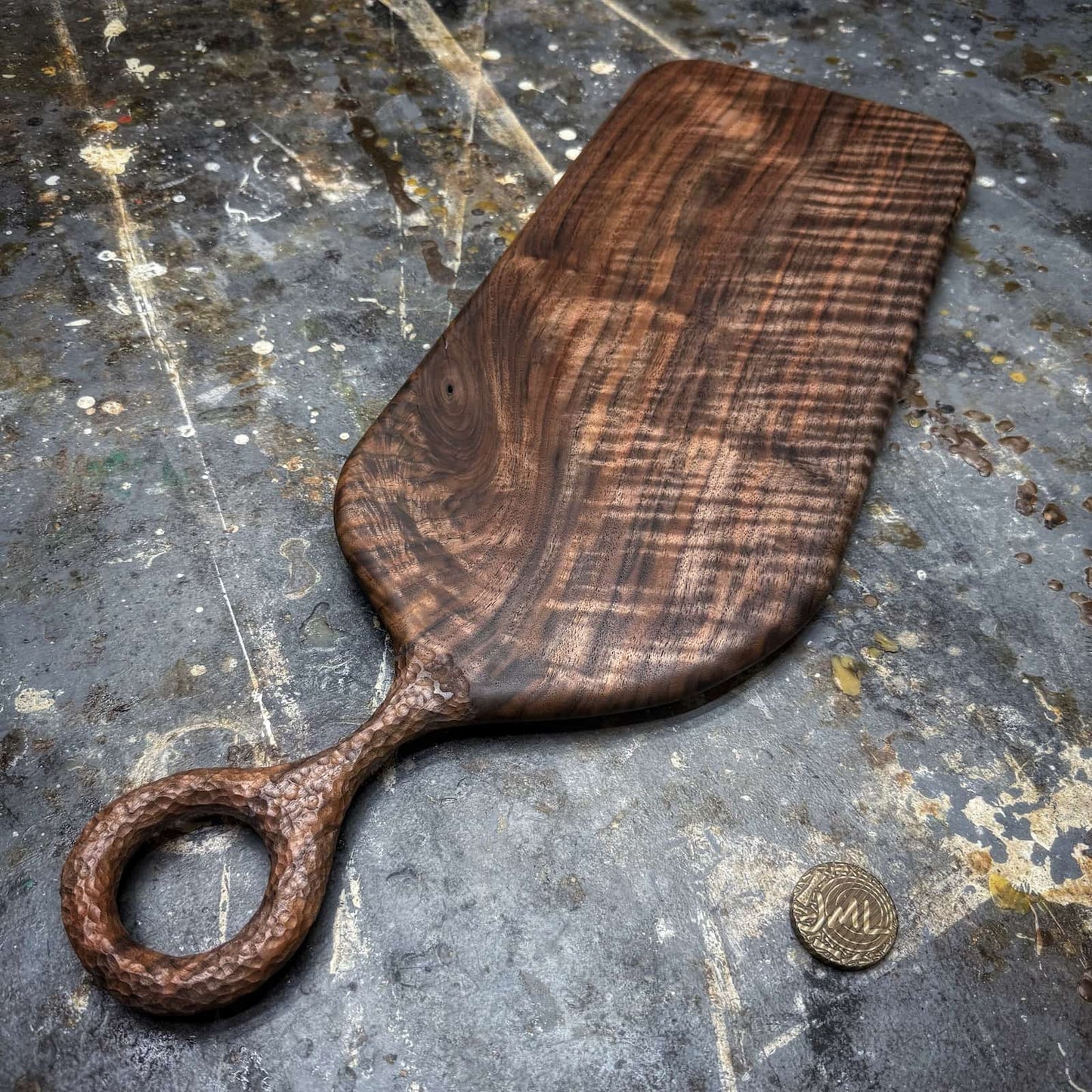 curly black walnut serving board with textured handle
