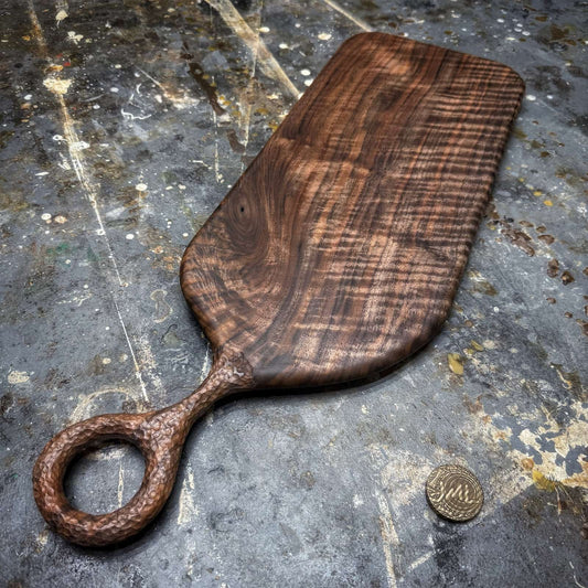 curly black walnut serving board with textured handle