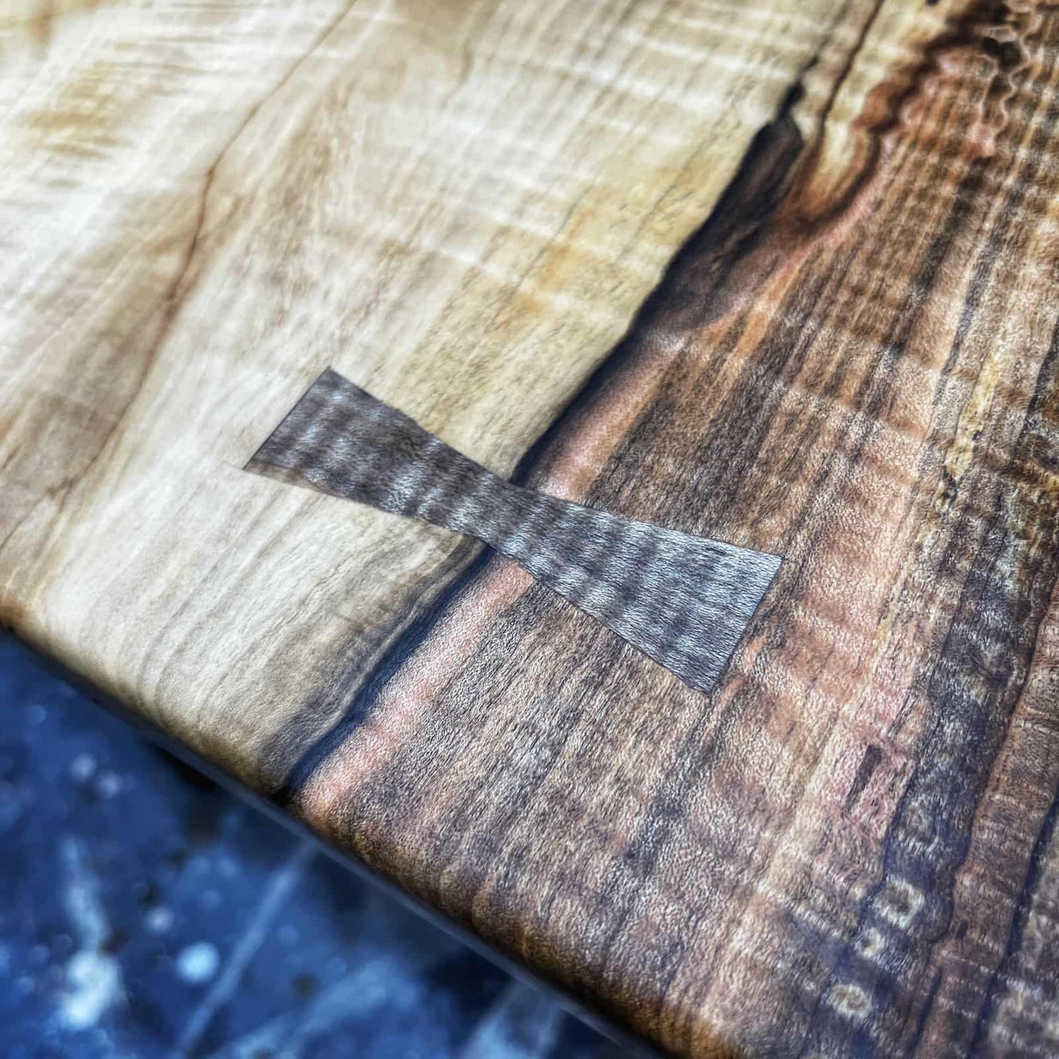 hand cut hardwood inlay with pronounced curl, subtle color variation, and finely shaped geometry crafted by JML Woodcraft