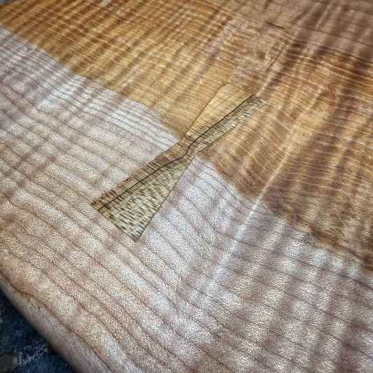 closeup of decorative maple inlay along natural wood transition