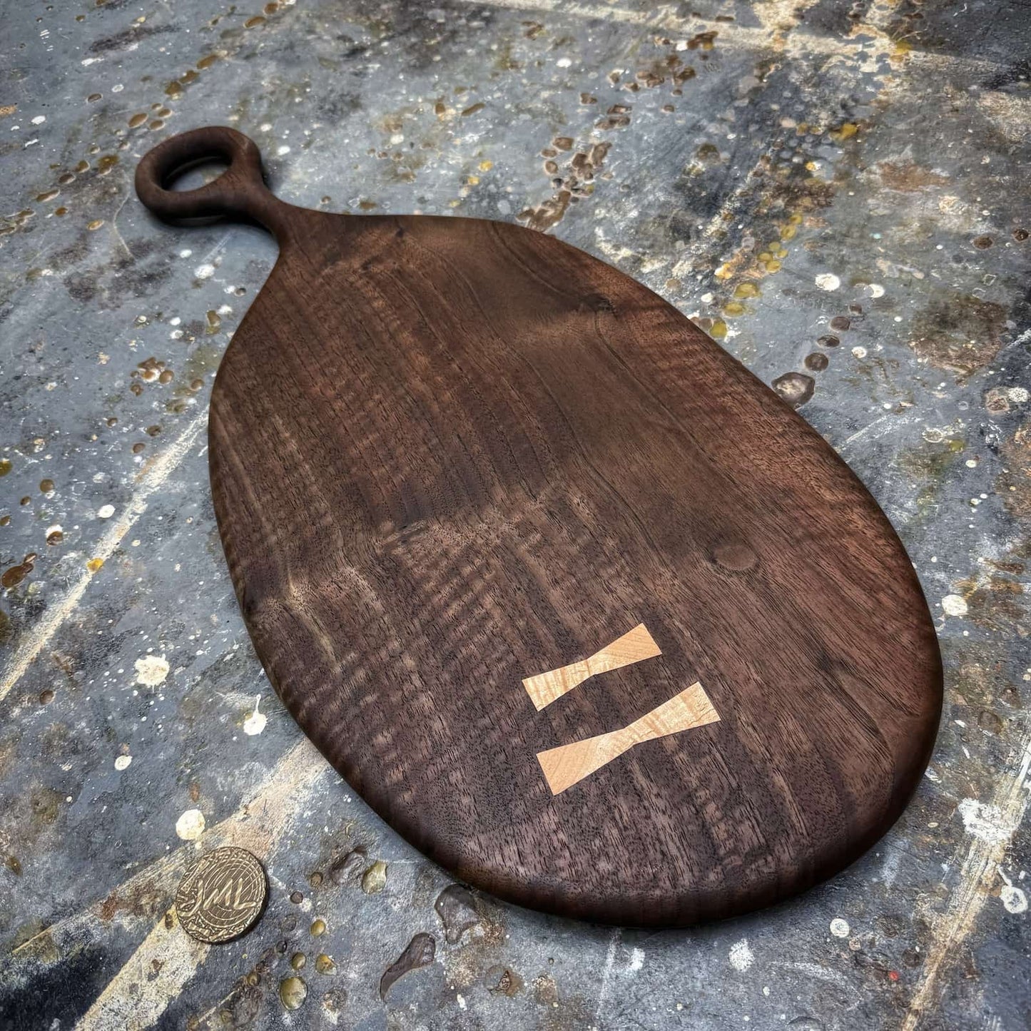 dark walnut serving board with smooth round handle