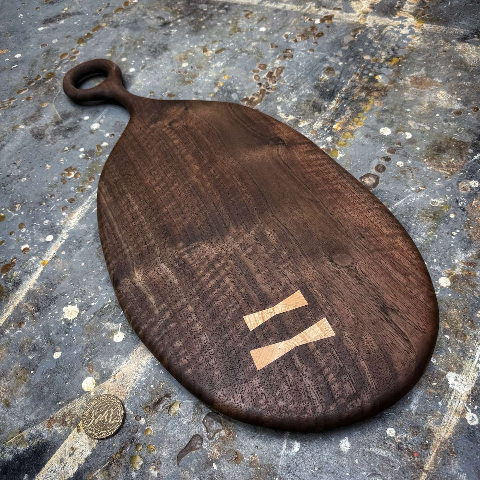 dark walnut serving board with smooth round handle