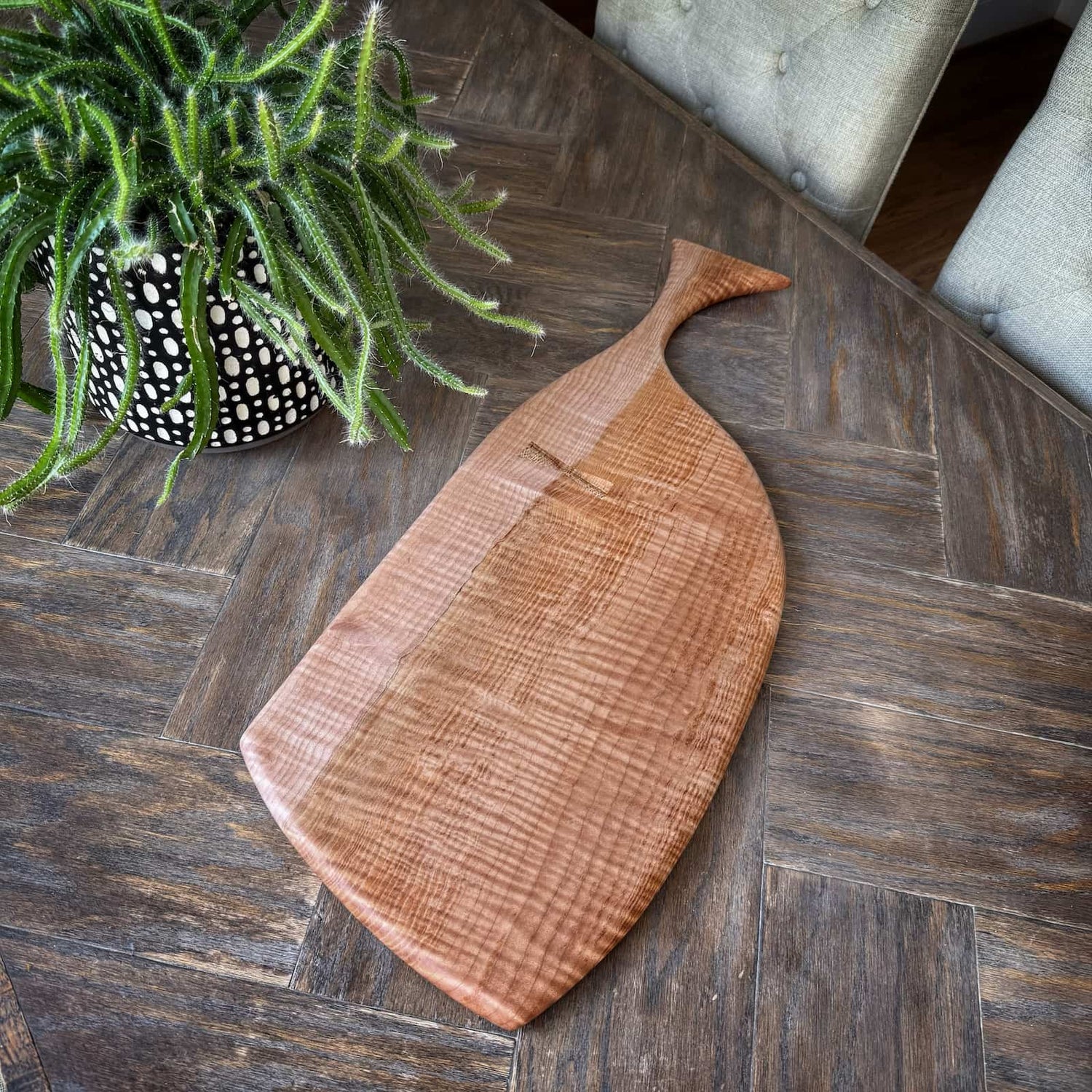curly maple hardwood serving board on herringbone table