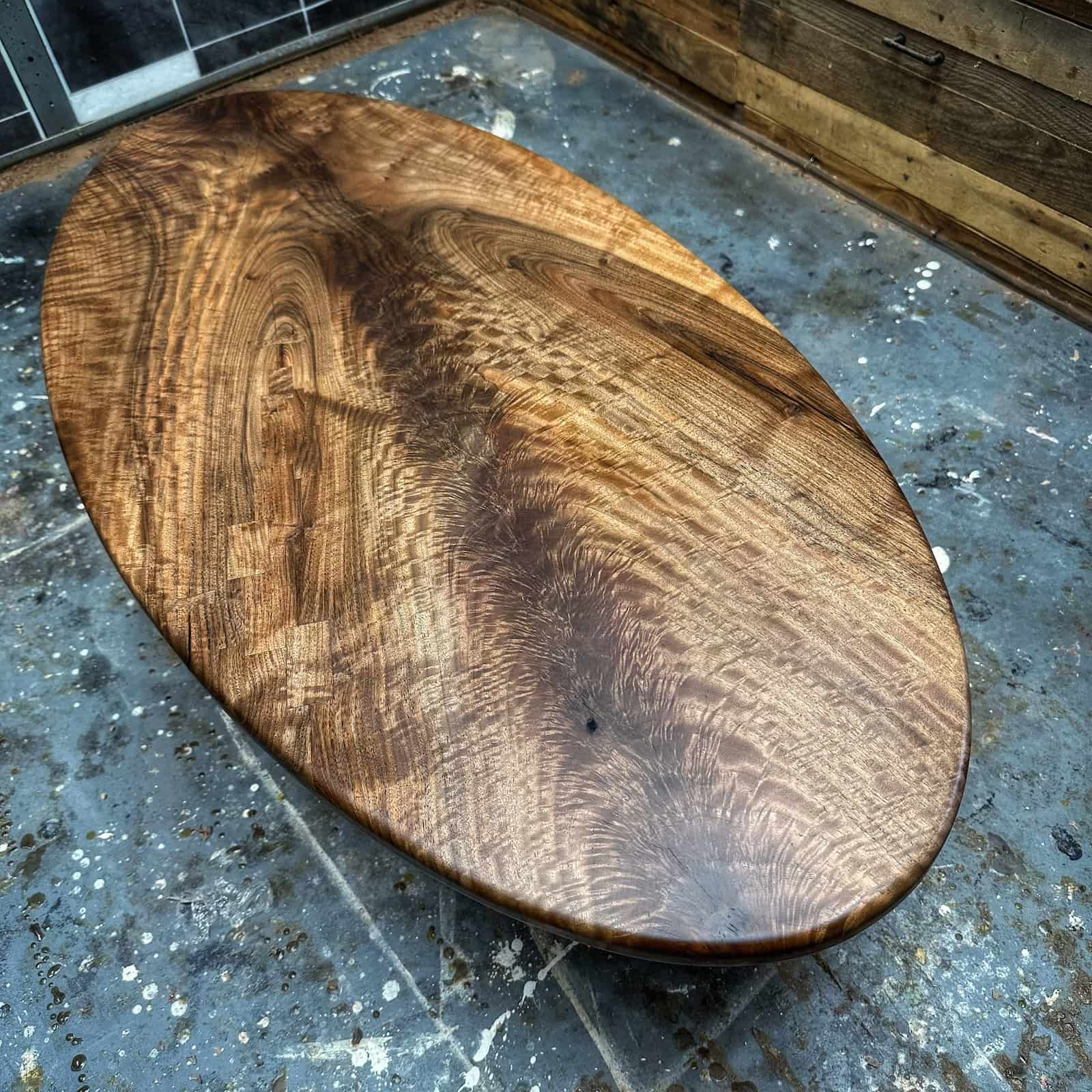 hand shaped hardwood table with sweeping grain detail, warm color variation, and a smooth flowing profile crafted by JML Woodcraft