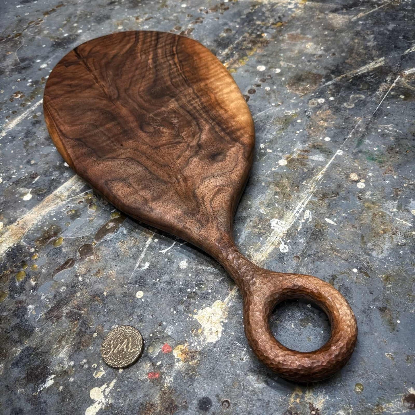 figured walnut serving board with hand-textured ring handle