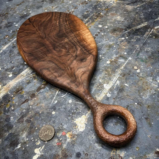figured walnut serving board with hand-textured ring handle