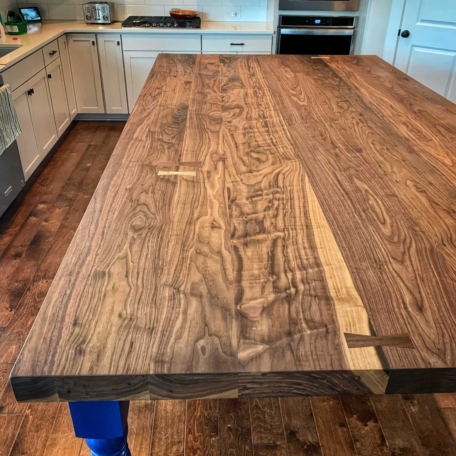 handcrafted hardwood surface with dramatic natural detail, warm tonal variation, and a refined furniture grade finish created by JML Woodcraft