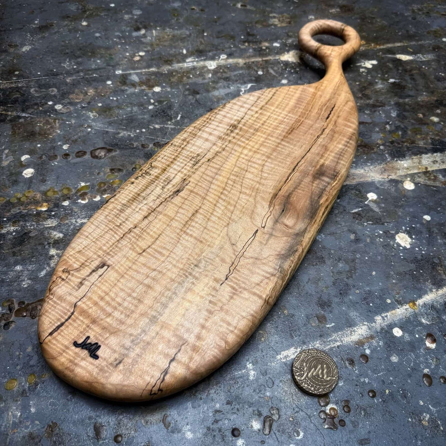 ambrosia maple serving board with ring handle photographed in workshop