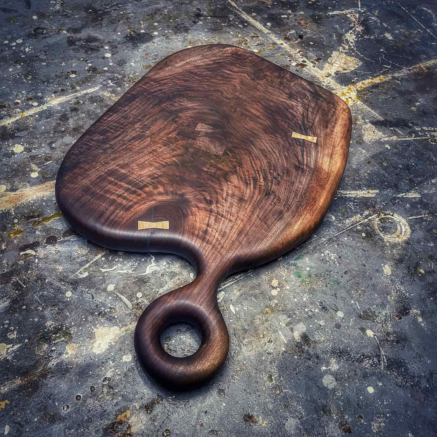 Chunky round walnut serving board handcrafted from figured hardwood