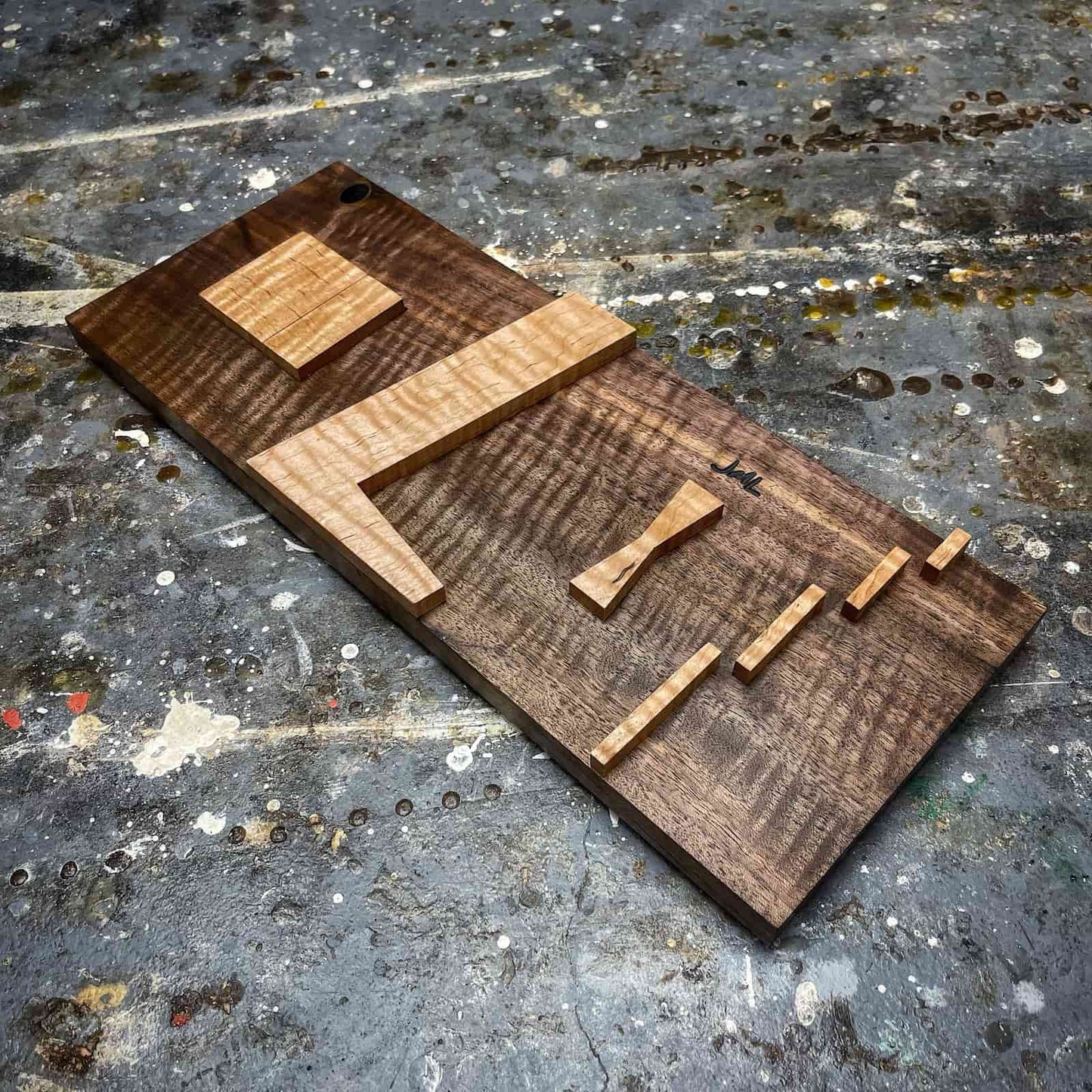 Single walnut JML inlay jig on display showing four inlay size capability