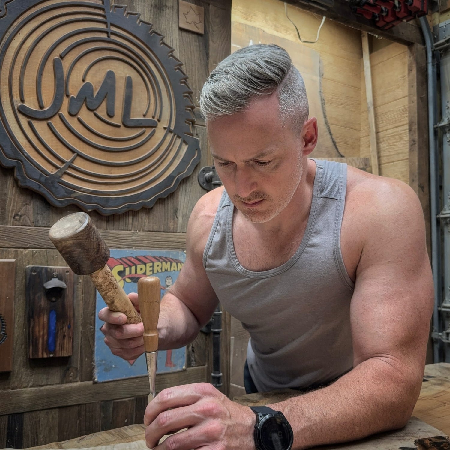 woodworker carving with mallet and chisel in the JML workshop