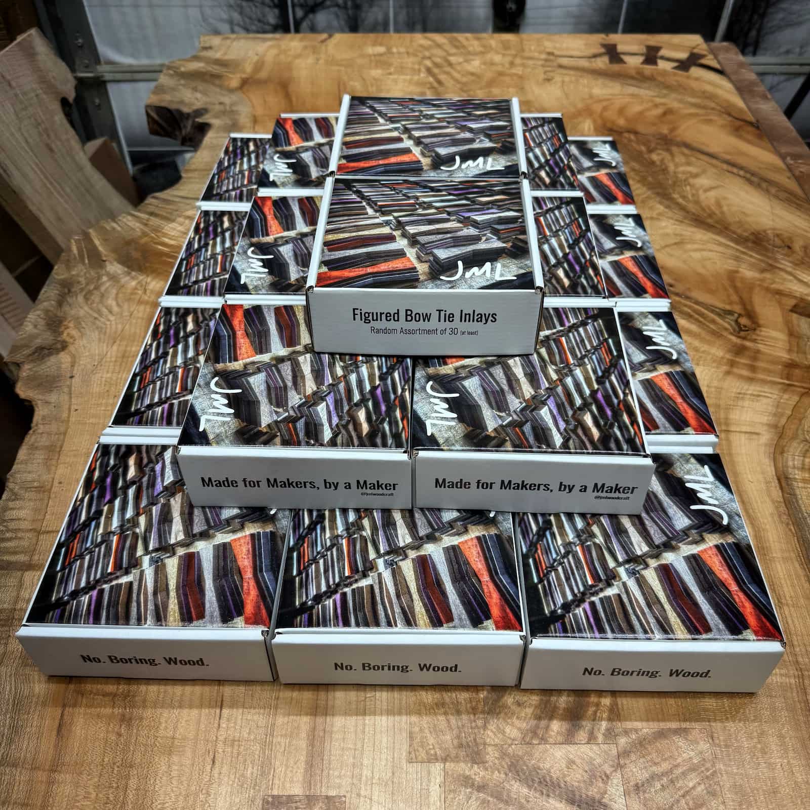 Pyramid display of JML Woodcraft bow tie inlay boxes stacked for presentation