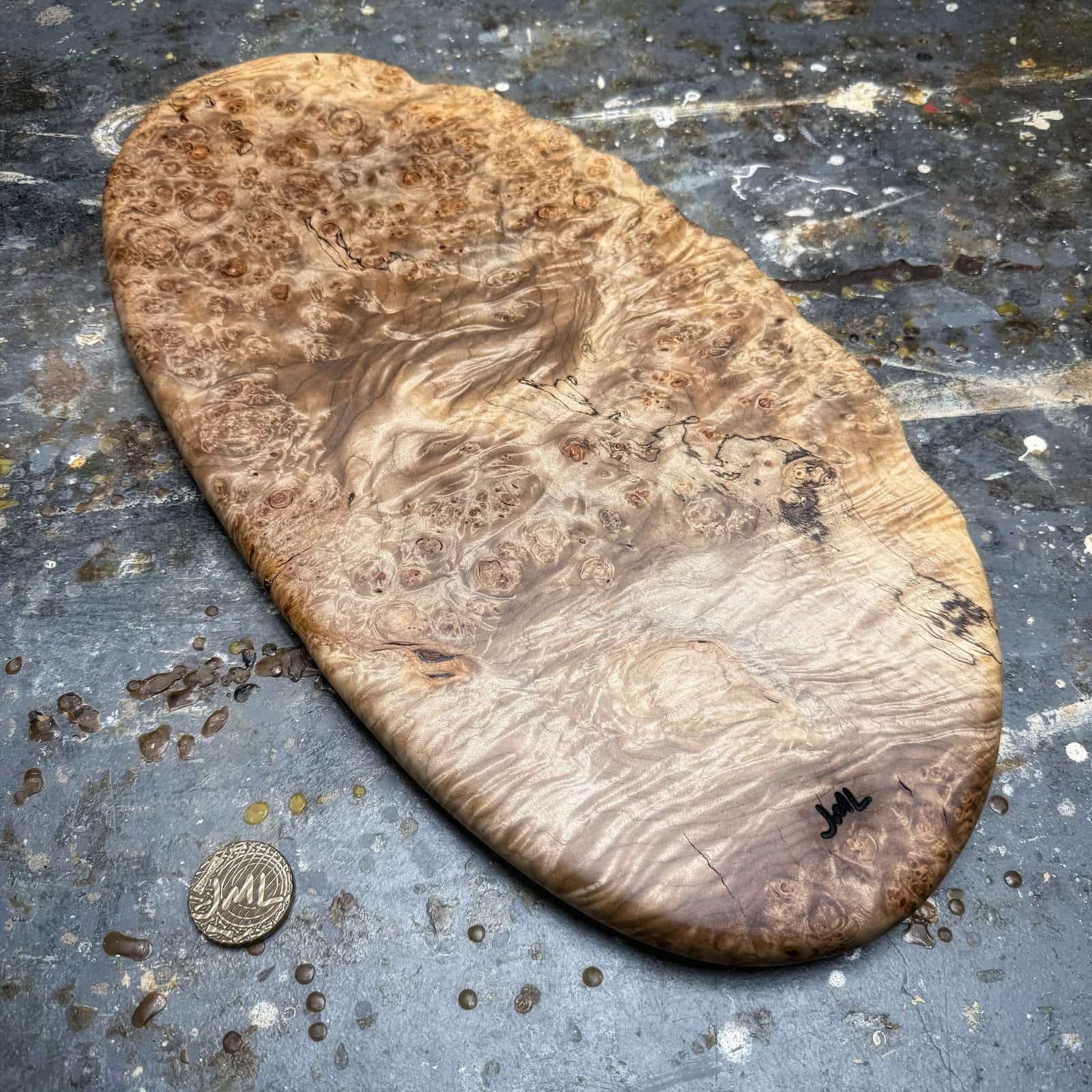 full board shot showing oval shape and dramatic burl pattern