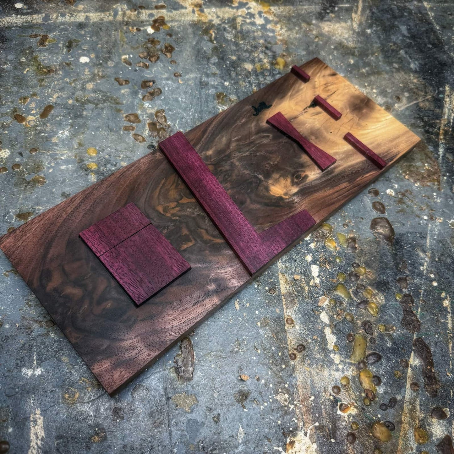 Detail of Purpleheart bow tie inlay component on figured walnut jig base