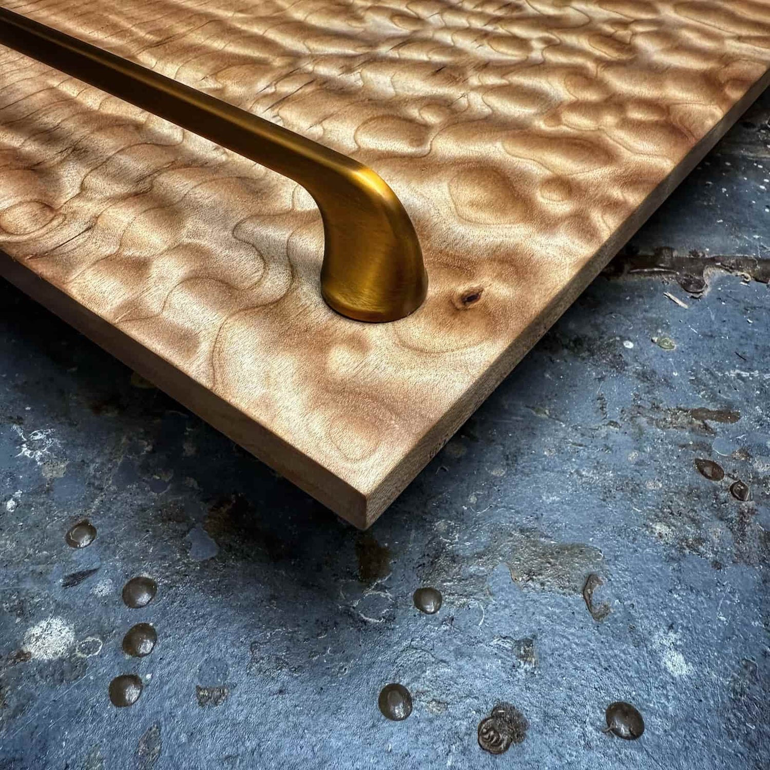 handcrafted hardwood tray with pronounced quilted figure, warm natural texture, and elegant metal handle detail created by JML Woodcraft