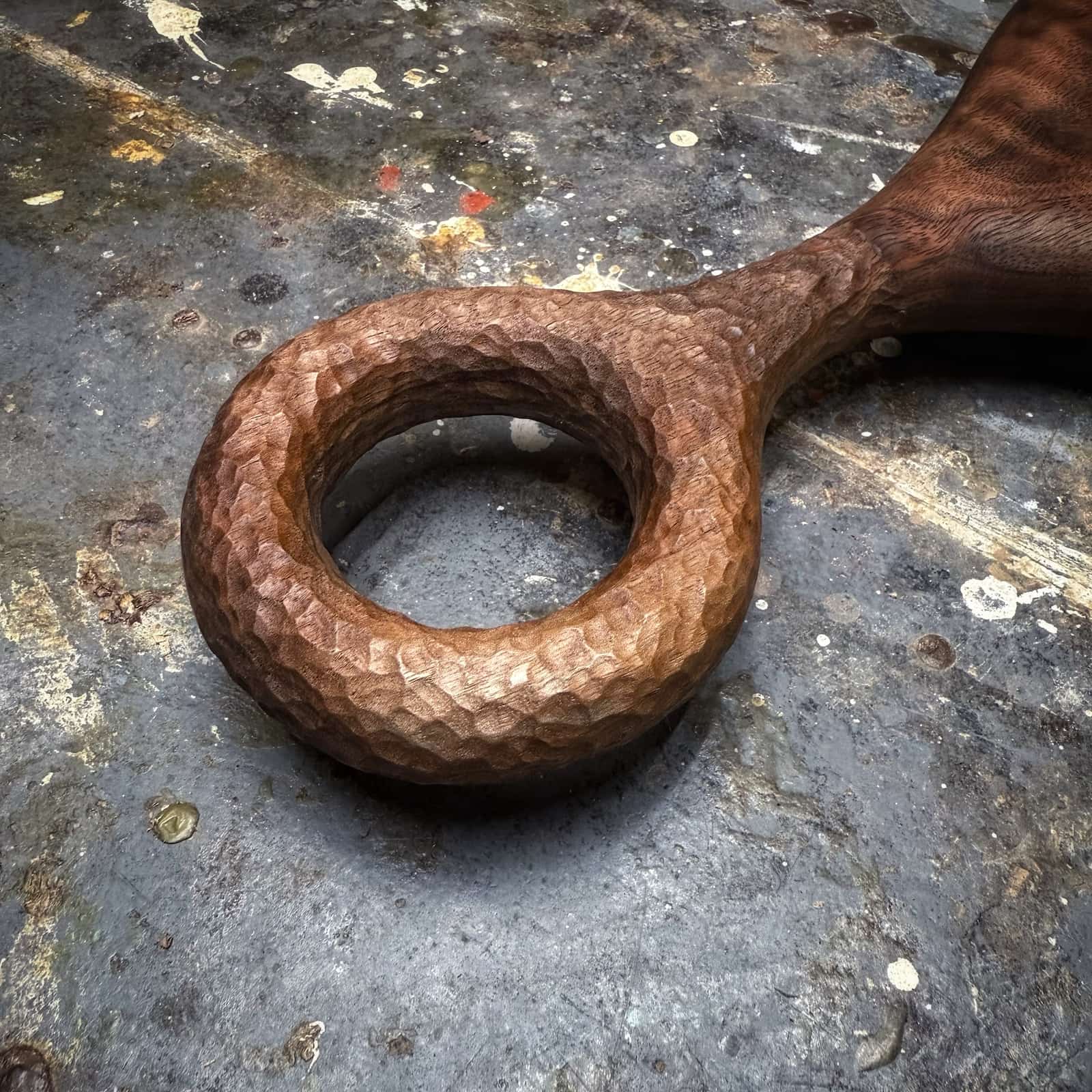 close-up of hand-textured walnut handle on serving board